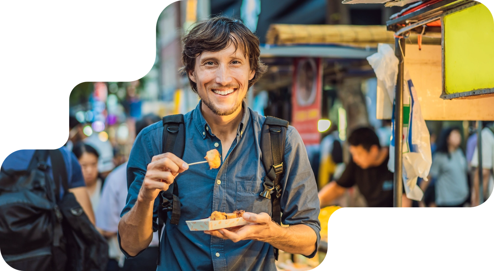 Guest tries street food on a skewer at a market stall, booking system for food tours