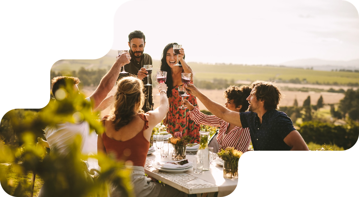 Guests raise glasses of red wine at an outdoor tasting, booking system for wineries and breweries